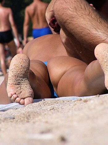 Dicking it in the sand at the shore with another dude.