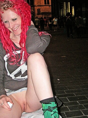 Here's a f*cking picture of some slutty hoe bitch with red dyed hair, looking like she just got the shit kicked out of her and some tramp stamp tats on her skinny legs.