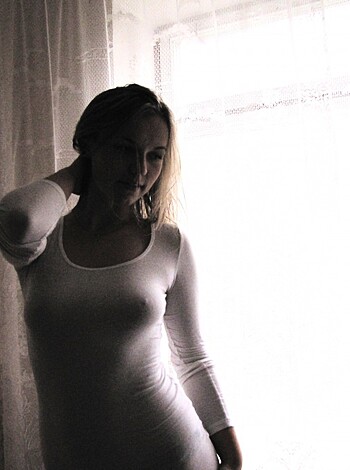 Tight-shirted titty-winking busty broad wearing a see-through bra.