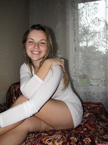 "Here's a photo of some hot chick laying down on her bed, tits out for all to see."