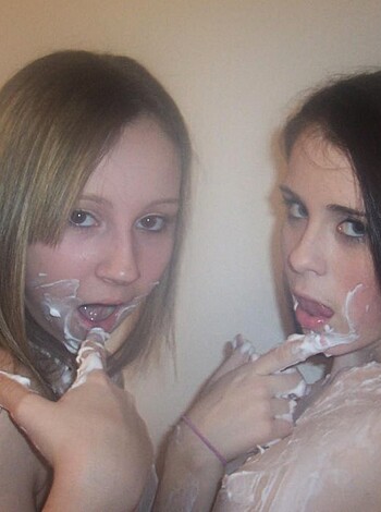 A pair of horny bitches sucking on one another's tits, with their tongues flicking and making goofy faces.