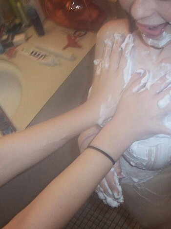 "Male hand rubbing tits on busty blonde chick."