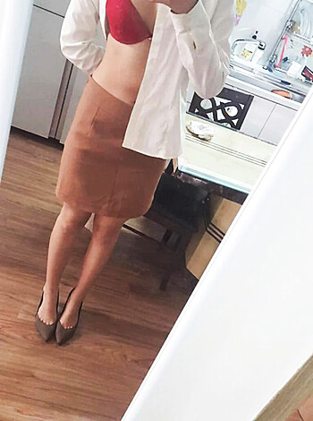 "A blatantly revealing outfit, with skinny jeans hugging her ass and a low-cut tank top showcasing her ample cleavage."