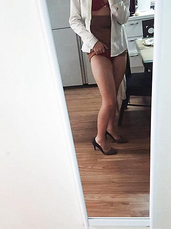 A busty blonde in a skimpy thong showing off her tits and tight ass, while sporting a sexy gold bracelet on her slender arm.