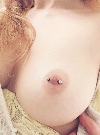 A busty broad with a pinned tit and some muffin top hangin' out.