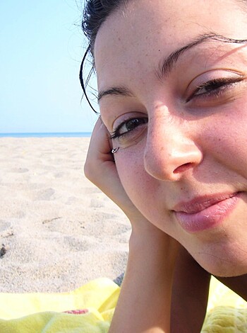 "Chick basking in the sun with hand up her cunt, staring at you."