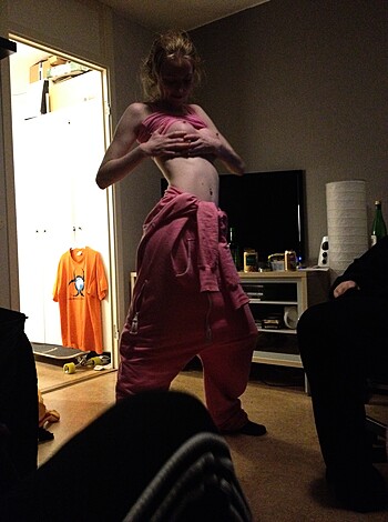 A hot chick with big titties is showing off her boobs while wearing pink fucking pants and a matching jacket.
