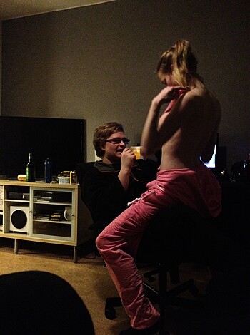 A stripping babe takes off her fucking pink pants as a dude watches on his ass, while they both remain completely nude with only their underwear on.