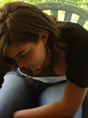 A slender blonde bitch sits her ass down on a plastic lawn chair, wearing tight-ass jeans that hug her curvy frame like a glove.