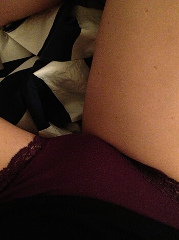 A woman with her ankle resting on top of her knee, suggesting she's turned on as fuck.