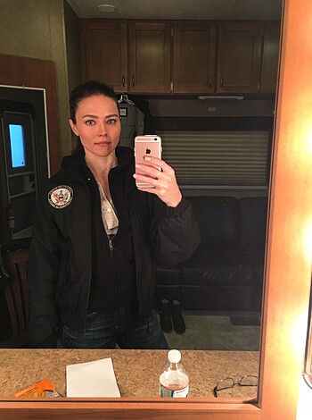 "Fuckin' chick taking a piss with an RV in the background, got some fuckin' NASA shit on her back."