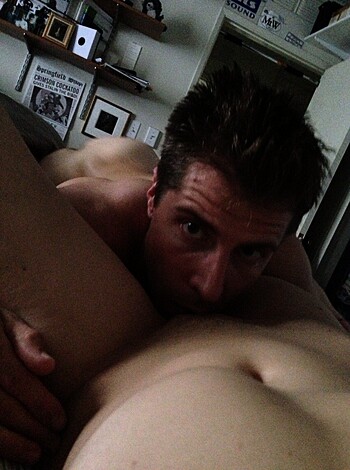 A dude is gobbling up a broad while she gives him head on the bed.