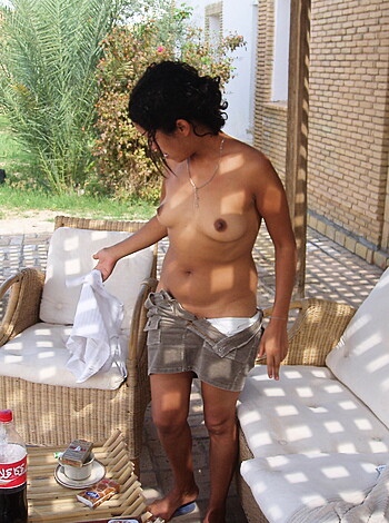 Look at this fucking picture of some slutty bitch lounging around on a cheap ass sofa, not wearing any damn shirt, showing off her tits and shit.