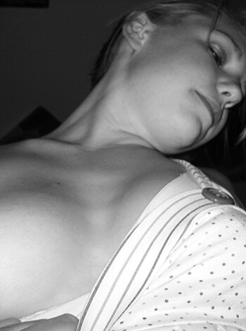 A naked chick with some ink on her tit.