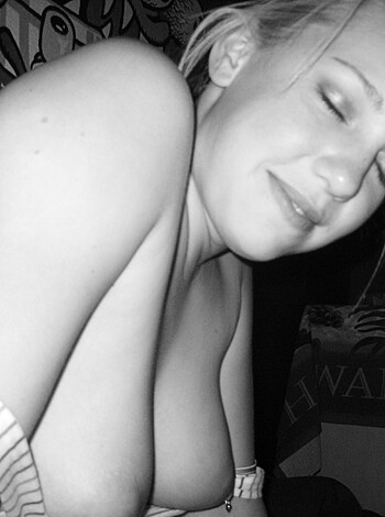 A naked bitch's tits is displayed for all to see.