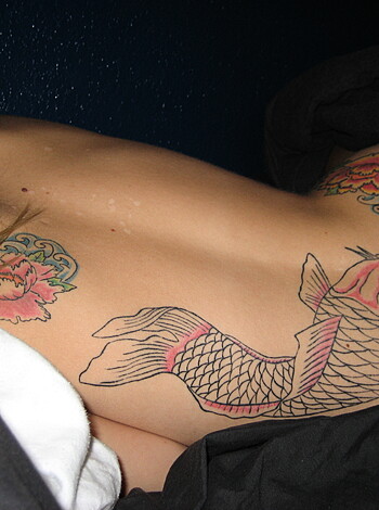 Here's a fucking photo of some asshole's back with shitty tats all over it.