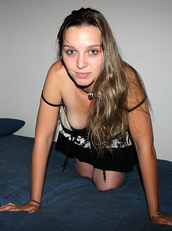 "Busty chick in her panties, ass up on satin sheets."