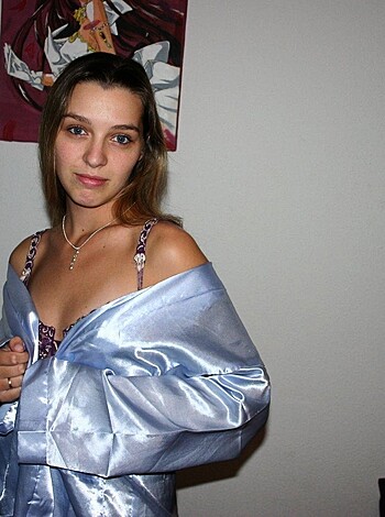 """
Babe in tight silver coat shows off her curves.
"""