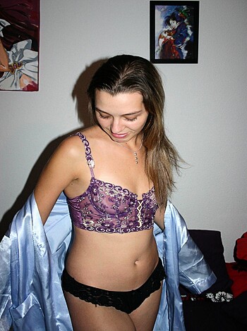 "A chick in her panties and robe, checking out her bicep."