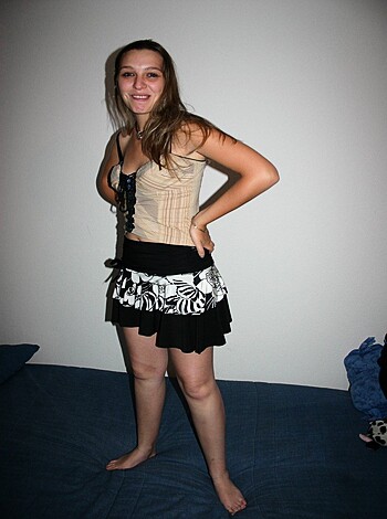 The image depicts a hot-assed babe sporting a sexy ass mini-skirt with a tight white top, and she looks like the kind of girl who can fuck all night long.
