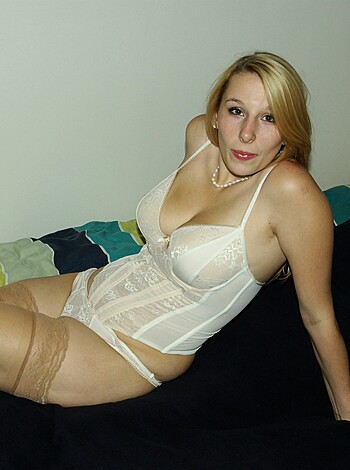 "Here's a picture of a hot babe, lying naked on her back with her ass up in the air. Her tits are hanging out of that sexy bra, and you can see her shaved pussy from the front."
