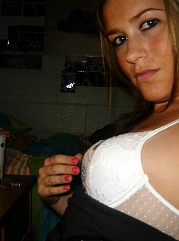 Here's an image of a busty broad with her lacy panties on full display, and her tits pushed up like two melons in a mesh top. She's got a tight body, but you can see right through that bra, man.