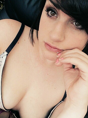 Here's the fucking vulgar description of the image:
The bitch is posing in her sexy ass lingerie, looking directly into the camera with a seductive expression on her face.