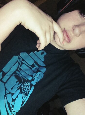 "Here's a photo of some fucking dude wearing a goddamn black t-shirt with earbuds jammed in his dickhead."