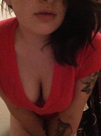 A naked chick with tits hanging out of her shirt, not wearing any pants.