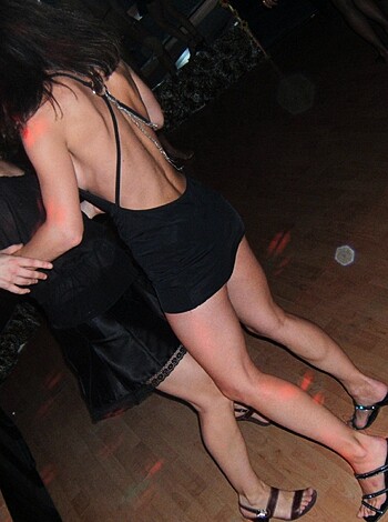 "Watch these two hot chicks grinding on each other's racks, showing off their toned tummies in skimpy dresses."