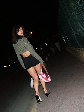The young bitch gets up close and personal with the night, while showing off her curvy ass to any prying eyes.