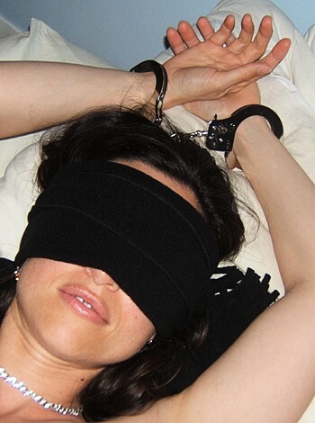 "Chick bound and gagged in bed, fucking herself silly."