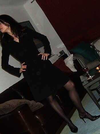 Here's the naked broad in her panties, standin' in some rich guy's living room.