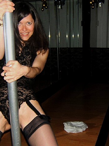 A busty broad squeezing a stripper pole like she's been fuckin' since kindergarten.