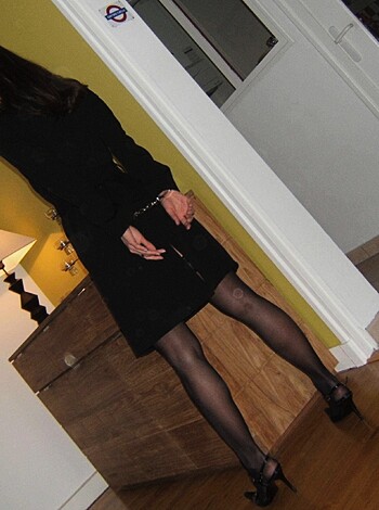 "This picture is of a hot chick wearing fucking sexy ass black stockings and a sweet little number, you can see the outline of her pussy through that thin fabric."