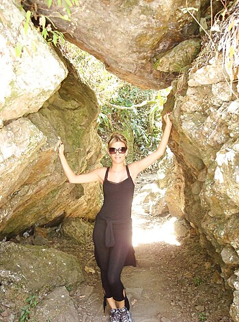 The blonde chick is fuckin' striking some poses in between those motherfuckin' rocks, yo!