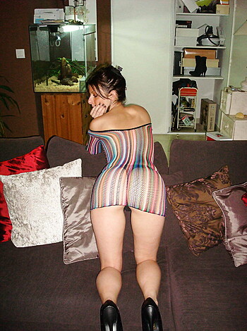 """
This image shows a chick with a hot ass wearing a brightly colored dress that exposes her bare butt cheeks.
"""
