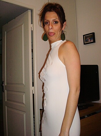 This is some bimbo posing with her tits out for a fuckin' picture, wearing some fruity ass dress and probably paid extra to look retarded as hell in front of the camera.