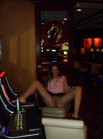 Here's a picture of some trashy slut trying to win big at the casino while showing off her cheap pussy.