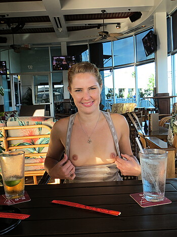 "Check out this fucking hot chick in her tight tits, enjoying some booze at the local dive bar. She's got that perfect smile on her face while she sips on her clear ass shit."