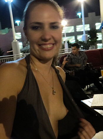 A naked titty chick with her boobs hanging out of her see-through dress.