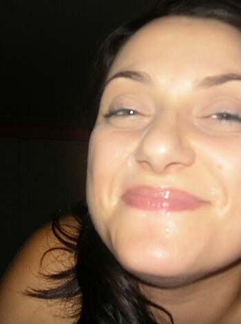 Here's a fucking tight shot of some slutty bitch grinnin' like an asshole, with her shitty eyes halfway shut.
