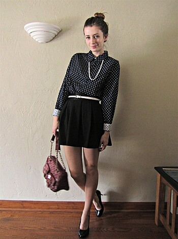 "Brown haired babe in short skirt with a fuckin' polka dot pattern, and a matching chain around her neck."