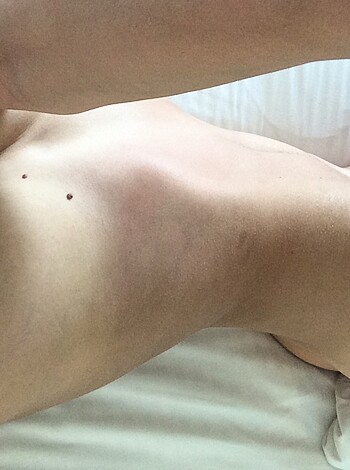 Here's a photo of a naked bitch stretched out on some goddamn sheets, you horny son of a motherfucking whore.