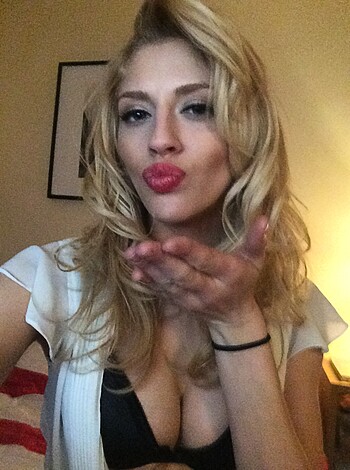 A smokin hot babe with sexy lace panties up on her ass is gettin' all lip-locked with her fingers, and you can see that she's totally feelin' it cause her tits are all perky as hell.