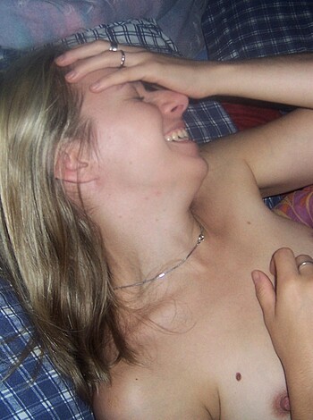 Lying there, cocking a grin
While spreading wide and giving it up
Her tits bounce, ass cracking
As she fingers herself to getting choking
On the bed, nude and ready
Fuckable as fuck and so hot that it's scorching