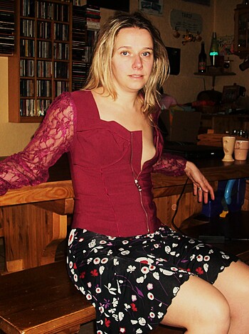 Here's a fucking hot chick in a tight red bra top and short, slutty black skirt with some dumb-ass flowers on it that are probably just there to try and hide her pussy from your prying eyes.