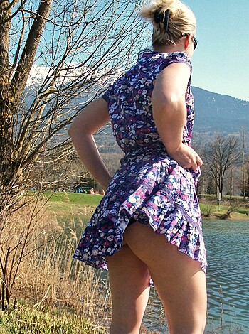 A sun-drenched park is the perfect backdrop for this sexy babe flaunting her shapely ass and short, denim miniskirt, as she flips it up high to show off her panties.