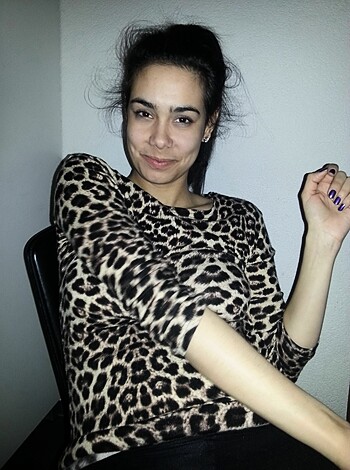 Look at this slutty bitch with her fucking leopard-print top, chilling like a total cunt on some ass she doesn't even own.
