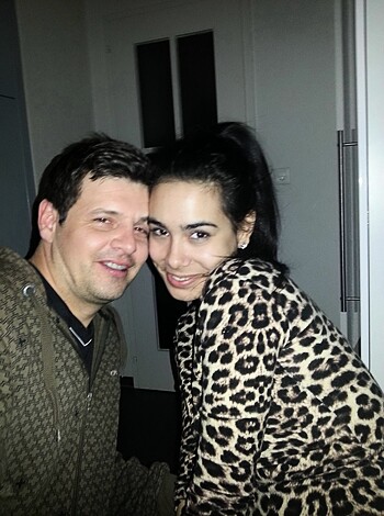 Vulgar description of image:
This is an amateur porn shot of a chubby milf with a dick-in-dress fucking her sloppy seconds boyfriend in their shithole basement while the fuckhole gives us a goofy grin for the camera.